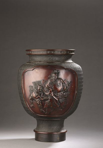 A bronze vase with a brown patina, decorated...