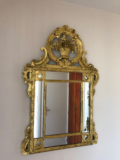 Gilded and carved wood mirror with rocaille...