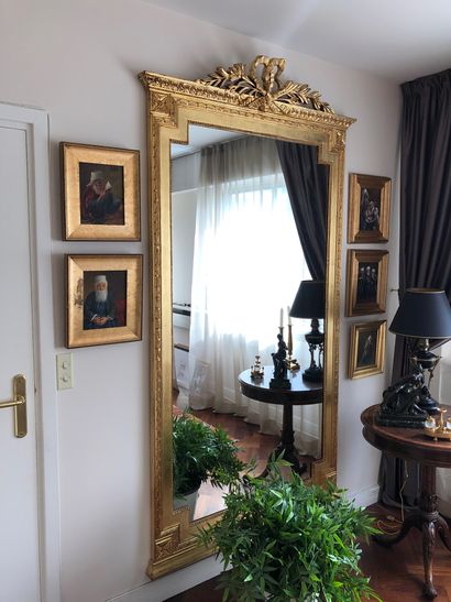 null Pair of large carved and gilded wood mirrors with a ribboned pediment, modern...