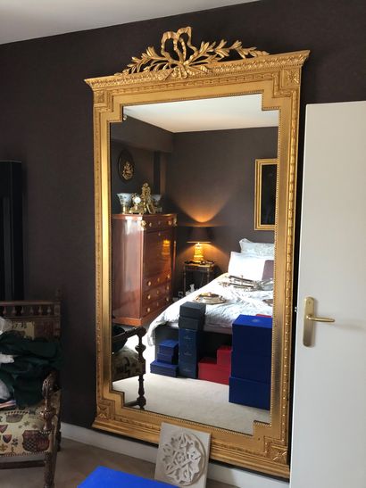 null Pair of large carved and gilded wood mirrors with a ribboned pediment, modern...