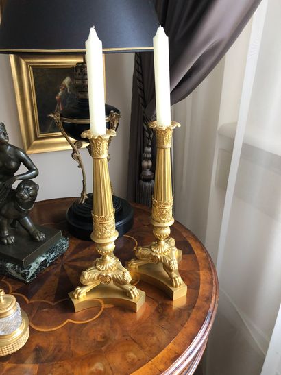 null A pair of chased and gilt bronze torches with palm and fluted decoration, standing...