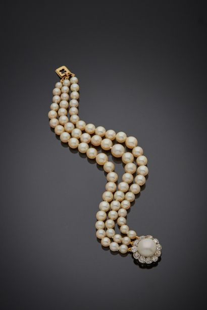 null A bracelet composed of three rows of falling cultured pearls, mounted on wires,...