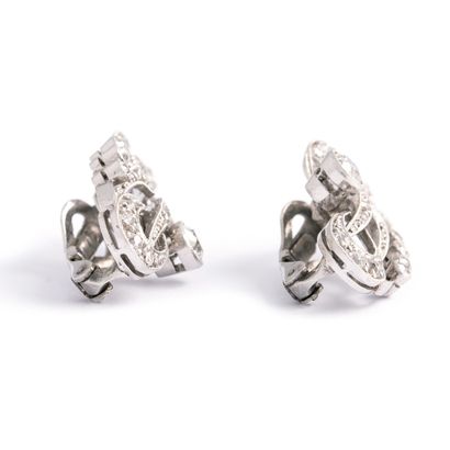 null Pair of platinum and white gold ear clips set with old cut diamonds.

Height:...
