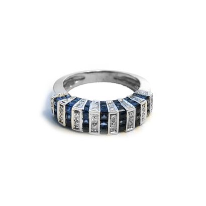 null White gold ring set with calibrated sapphires and round diamonds.

Finger size:...