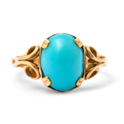 null An 18K yellow gold ring centered on a cabochon-cut turquoise stone.

Finger...