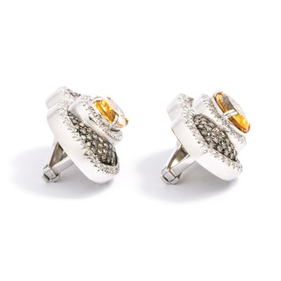 null Pair of ear clips in 18K white gold set with round brown and white diamonds,...