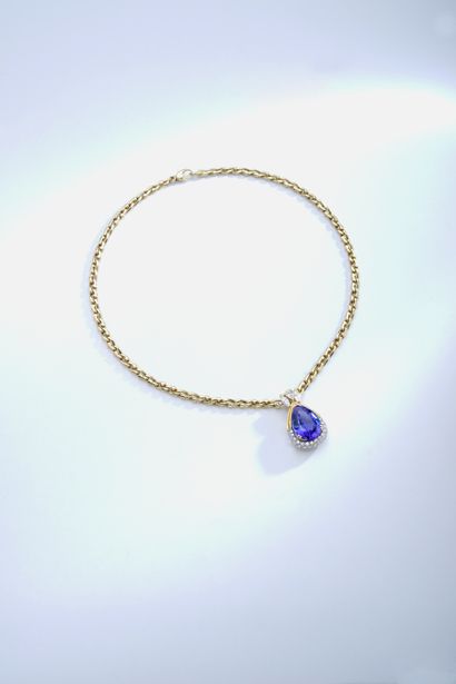 null Gubelin.

An 18K yellow gold pendant centered on a pear-cut tanzanite weighing...