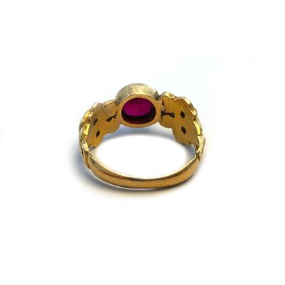 null An 18K yellow gold ring centered on a round ruby.

Finger size: 58.

Gross weight:...