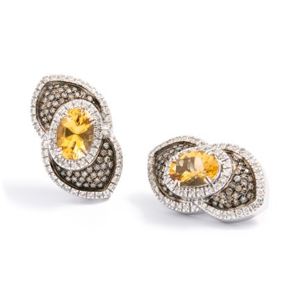 null Pair of ear clips in 18K white gold set with round brown and white diamonds,...