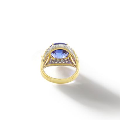 null Gubelin.

An 18K yellow gold ring centered on a cushion-cut tanzanite weighing...
