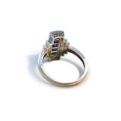 null An 18K white gold ring set with round diamonds and calibrated sapphires.

Finger...