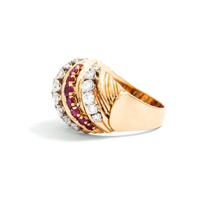 null 18K yellow gold ring set with round diamonds and rubies.

Weight of the diamonds:...