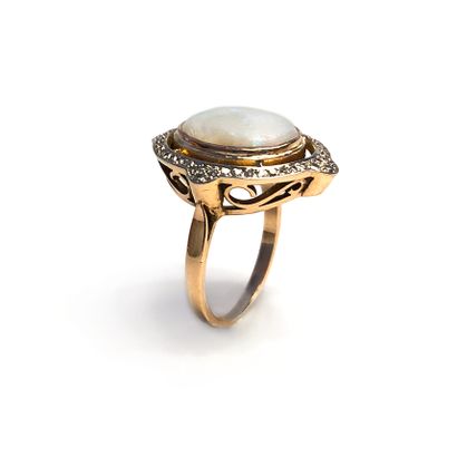 null An 18K yellow gold ring centered on an opal surrounded by diamonds.

Finger...