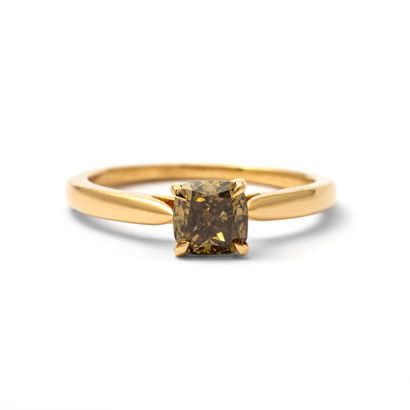 null Solitaire ring in 18K yellow gold centered with a cushion-cut diamond weighing...