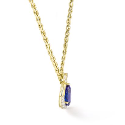 null Gubelin.

An 18K yellow gold pendant centered on a pear-cut tanzanite weighing...