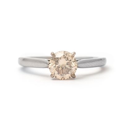 null Solitaire ring in 18K white gold centered with a round diamond weighing 1.19...