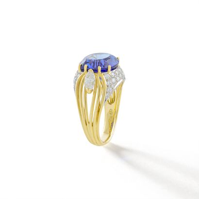 null Gubelin.

An 18K yellow gold ring centered on a cushion-cut tanzanite weighing...