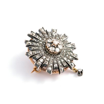 null A gold and silver star brooch set with old cut diamonds.

Late 19th century.

Height:...