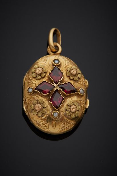 null An 18K yellow gold 750‰ oval-shaped medallion pendant adorned with a flower,...