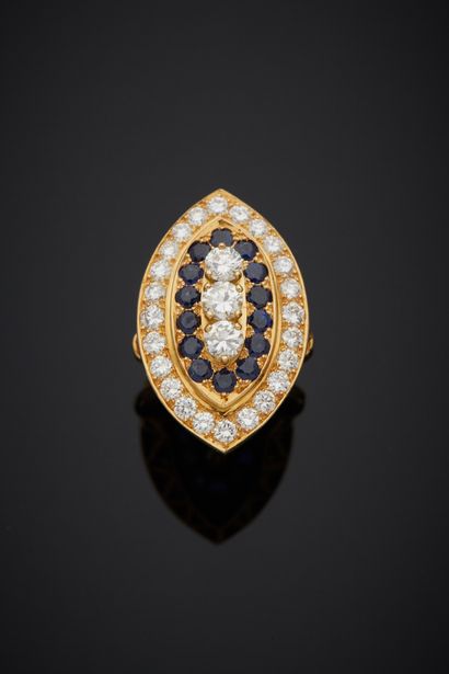 null An 18K yellow gold 750‰ marquise ring, set at its center with a line of three...