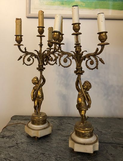 A pair of four-armed gilt bronze candelabras,...