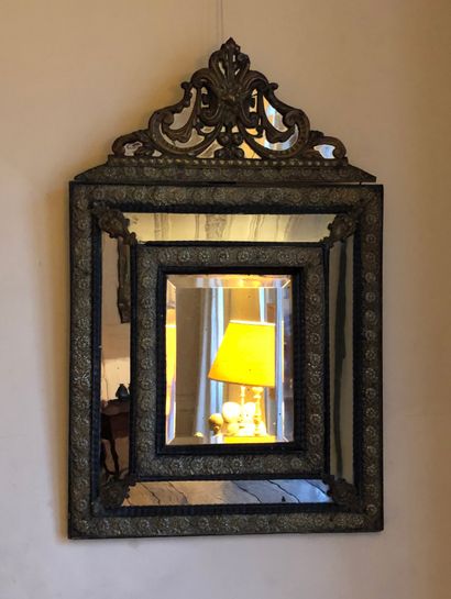 Hammered brass mirror with flowery friezes,...