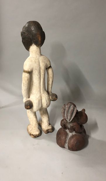 null Lot including two African statuettes, one in painted wood and the other in terra...