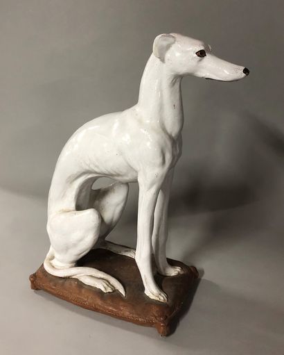 null A greyhound in white enamelled terracotta. 

Small missing parts and accidents.

H....
