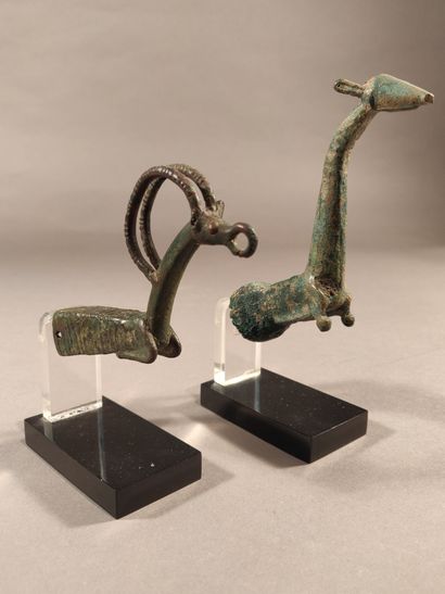 null Two bronze sharpening handles, one of which represents a protome of ibex and...