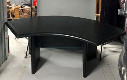 Curved desk, top and base covered with leather....