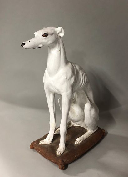 A greyhound in white enamelled terracotta....