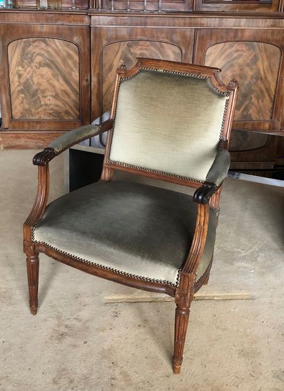 null Molded and carved wood armchair, back in gendarme hat, armrests and tapered...