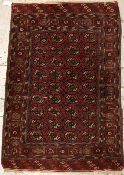 null Bukhara carpet decorated with guhls on a wine-red background, ten borders.

Wear...