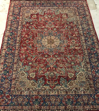 Large Persian carpet with red background,...