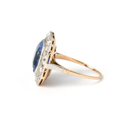 null 18K yellow and white gold ring centered with a cushion cut sapphire.

Sapphire...