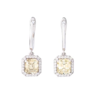 null Pair of 14K white gold earrings set with diamonds including in the center respectively...