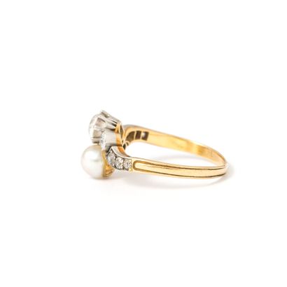 null 18K yellow gold and platinum ring set with old cut diamonds and a pearl.

Early...