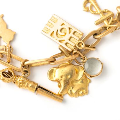 null Bracelet in 9K, 14K and 18K yellow gold holding numerous pendants and charms...
