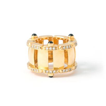 null 18K yellow gold band ring set with round diamonds, accented with cabochon sapphires.

Finger...