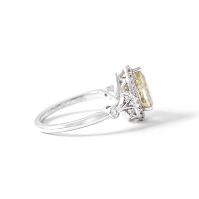 null 14K white gold ring set with diamonds including a pear-cut center diamond weighing...