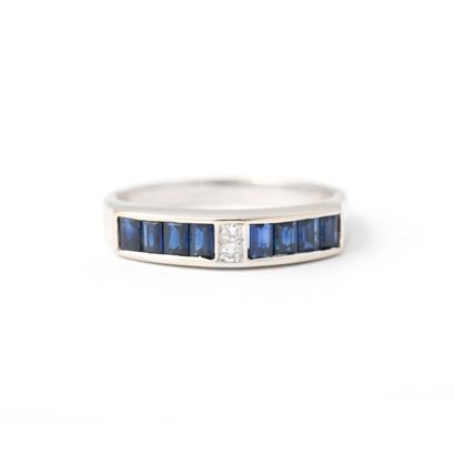 null 18K yellow gold ring set with calibrated sapphires and two diamonds.

Marked...