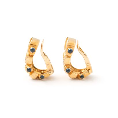 null Pair of 18K yellow gold earrings set with round diamonds and enhanced with cabochon...