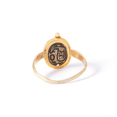 null 9K yellow gold ring centered with a cracked and carved soapstone representing...