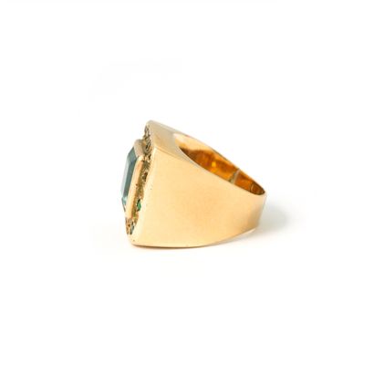 null 18K yellow gold ring centered on a square-cut aquamarine surrounded by emeralds.

Misses,...