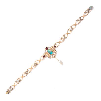 null Necklace in 18K gold set with an opal, pearls and garnets.

Art Nouveau. Circa...