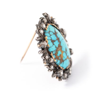 null 14K gold and 800‰ silver brooch centered with a matrix turquoise surrounded...
