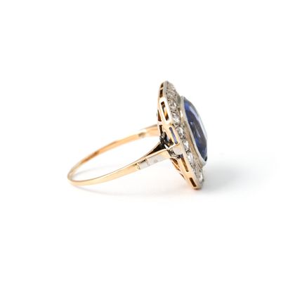null 18K yellow and white gold ring centered with a cushion cut sapphire.

Sapphire...