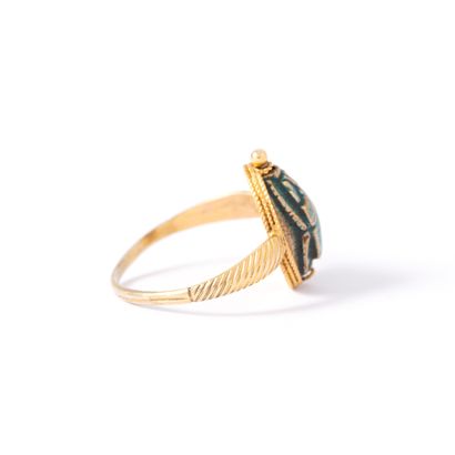 null 9K yellow gold ring centered with a cracked and carved soapstone representing...
