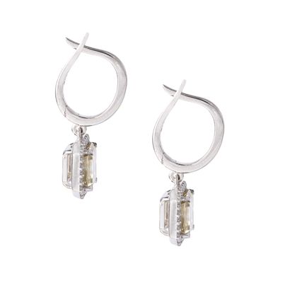 null Pair of 14K white gold earrings set with diamonds including in the center respectively...