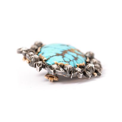 null 14K gold and 800‰ silver brooch centered with a matrix turquoise surrounded...
